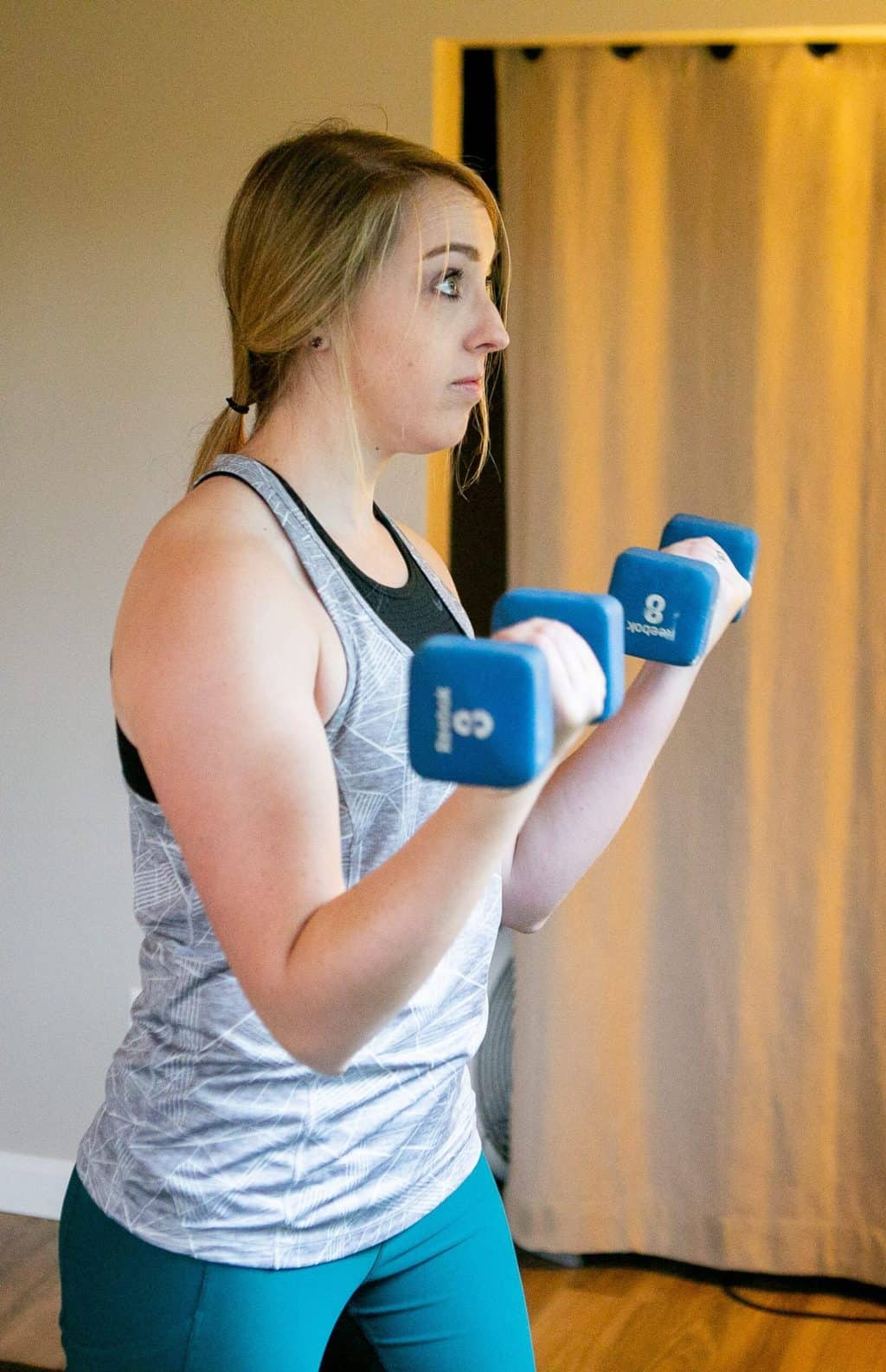 A woman doing dumbbell curls