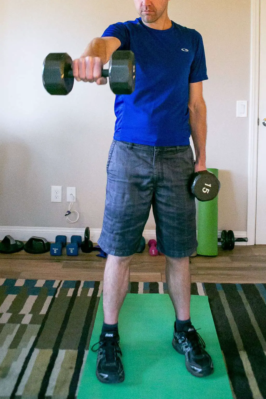 A man doing a dumbbell arm raise workout
