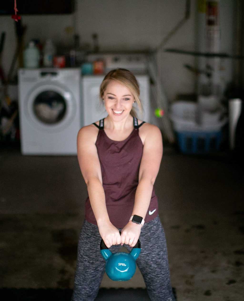 Woman swinging a kettlebell away from her body