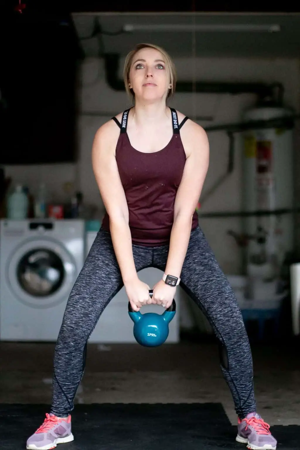 Woman trying to swing a kettlebell