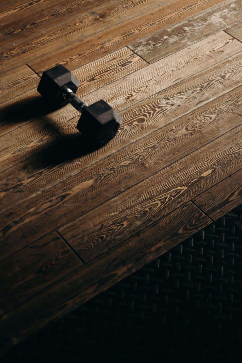 Dumbbell on a brown wooden surface