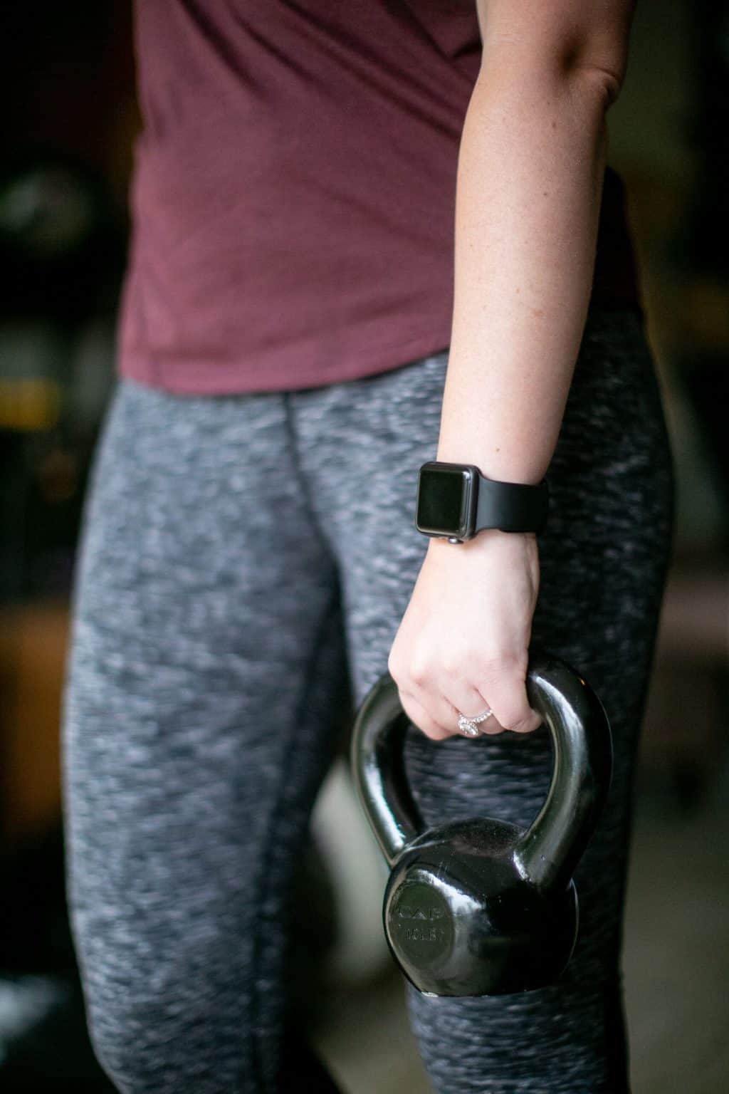 Woman holding a kettlebell with one hand