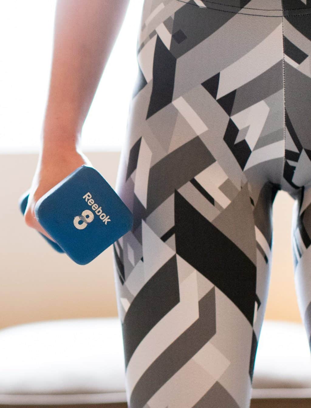 Woman holding a blue dumbbell