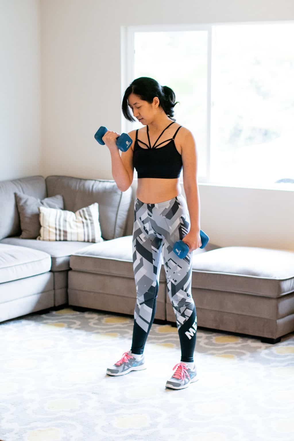 Woman doing a bicep curl with one arm