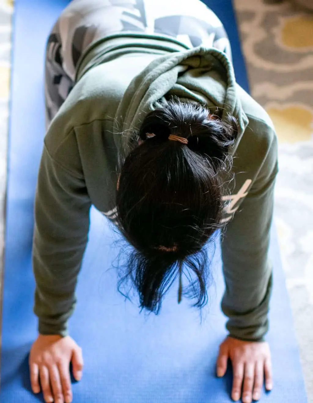 Woman doing push ups on blue yoga mat