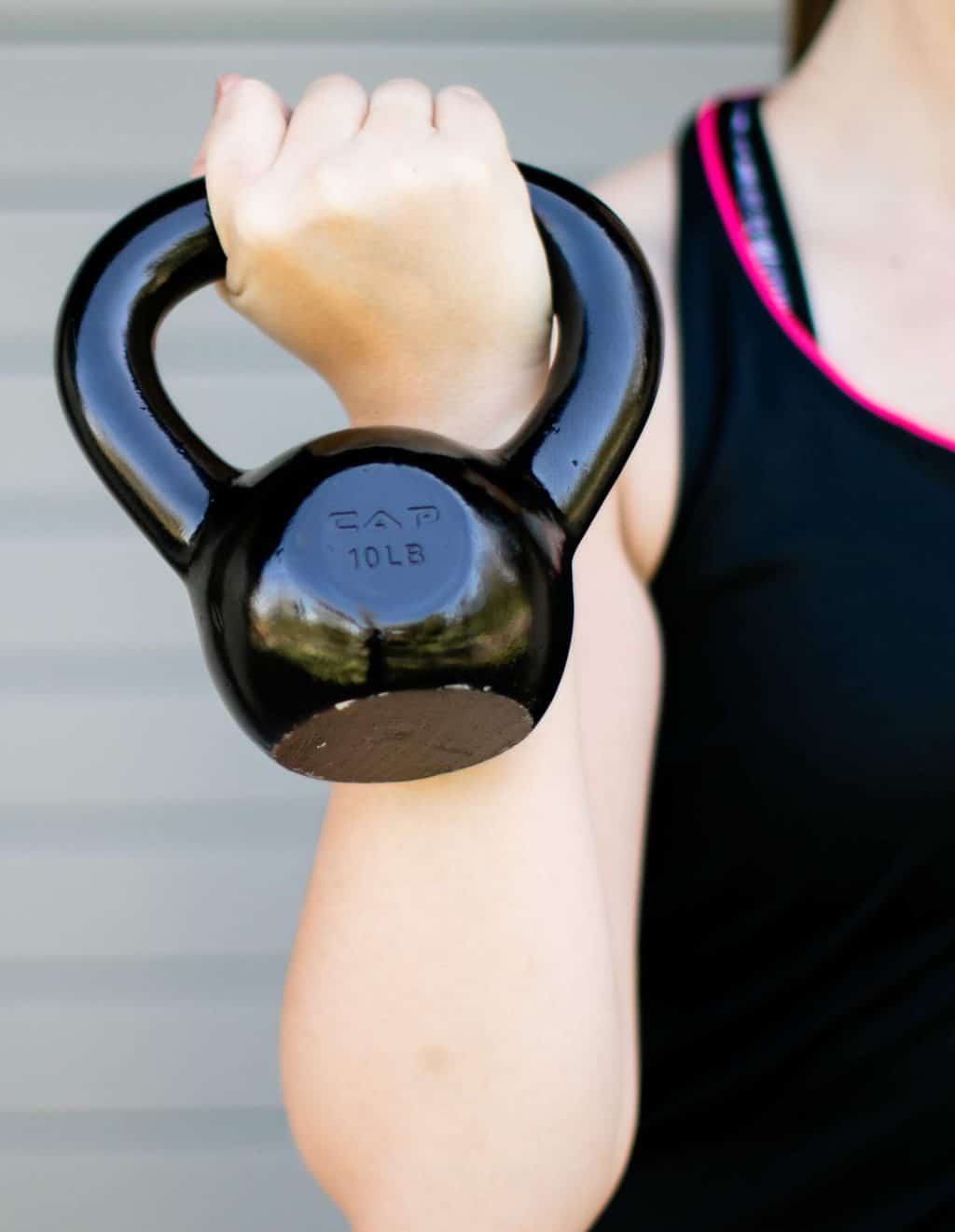 Woman carrying a kettlebell