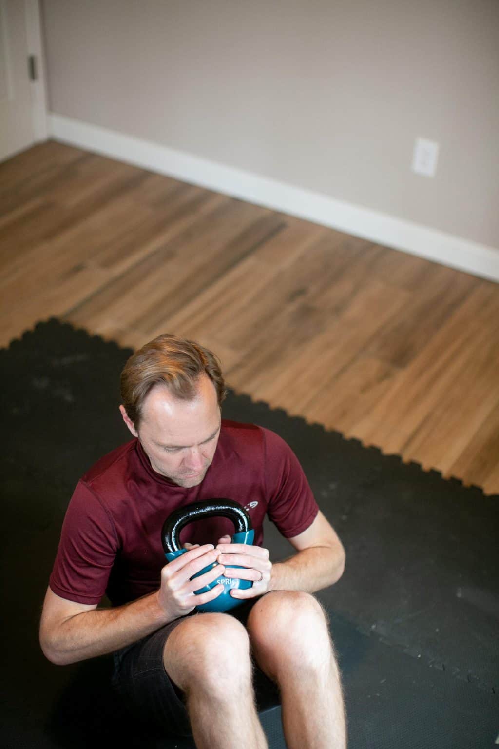 Man doing core workout with a kettlebell