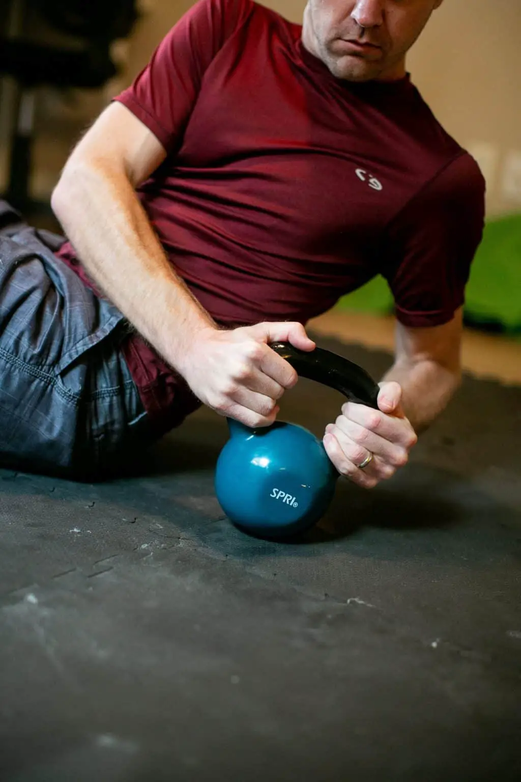 Man turning sideways while gripping a kettlebell